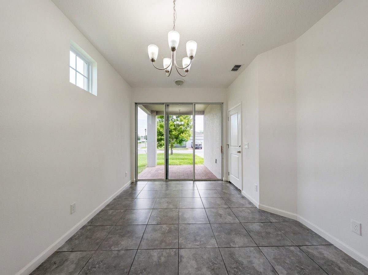 Living and dining area with sliding glass doors to the backyard at 2275 Abilia Aly, Apopka